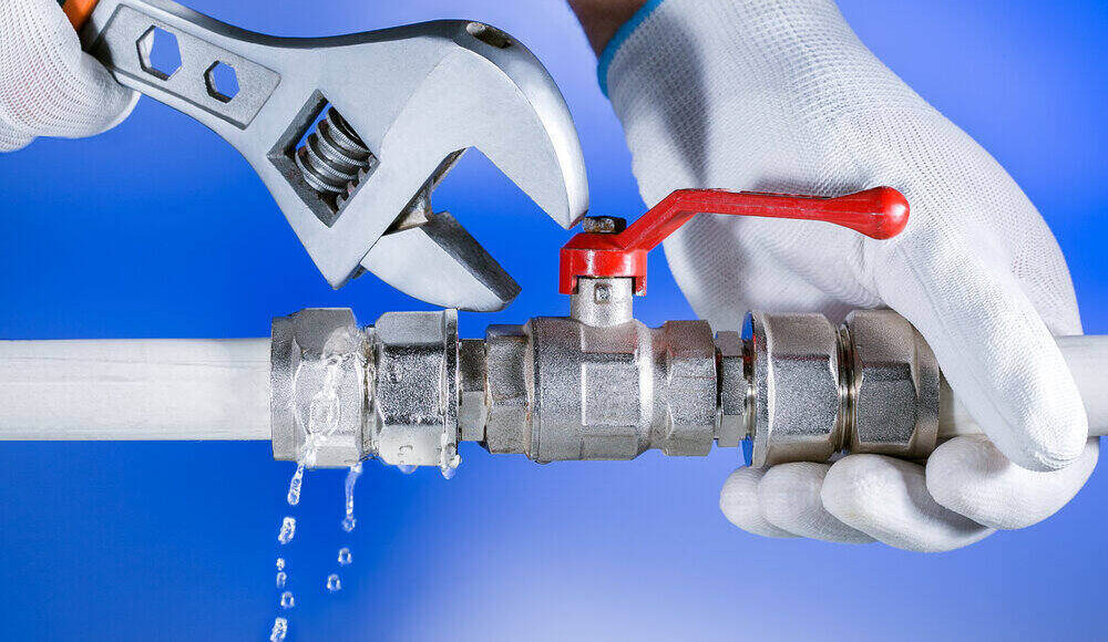 Plumber's hands working on pipe repair
