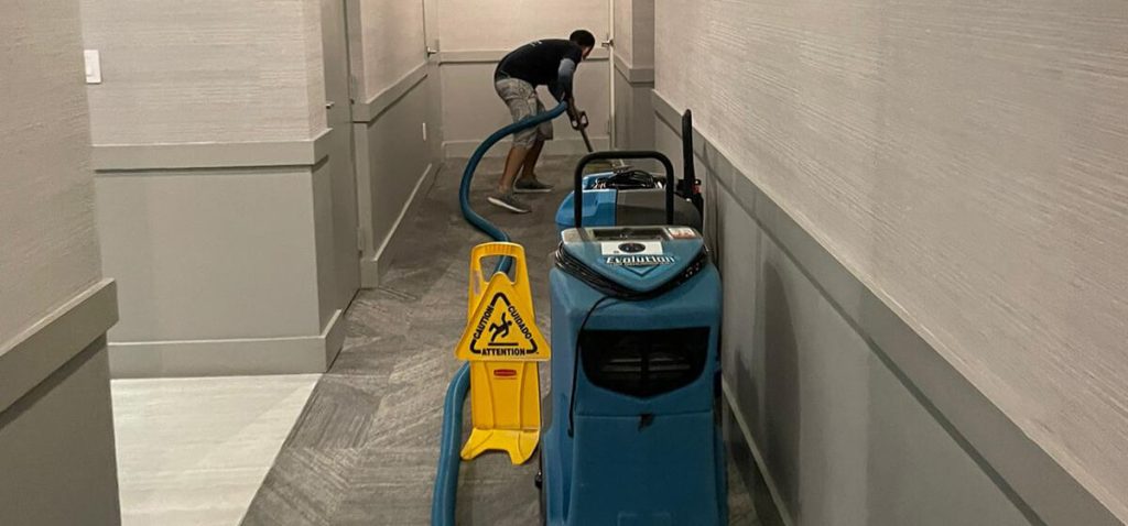 Technician performing water damage repair inside a property