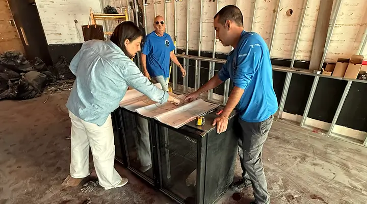 Technicians working alongside a client during a restoration project